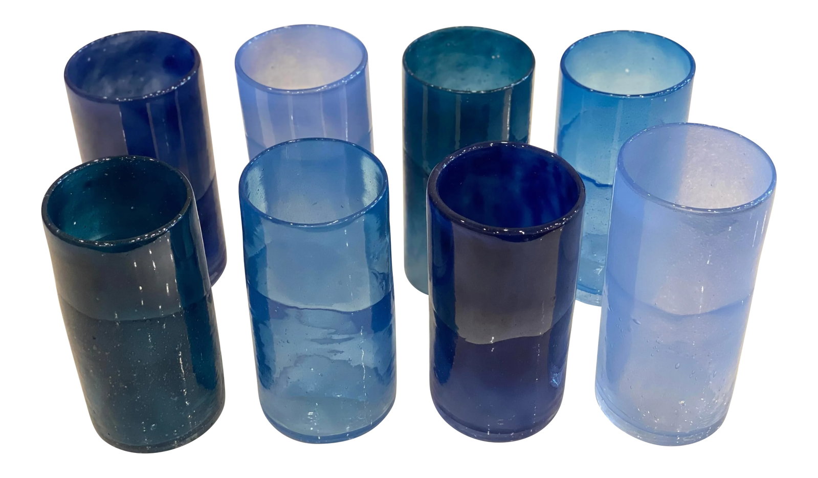 Blue Blown Glass Drinking Glasses - Set of 8: This set of 8 glasses in various shades of blues are a wonderful addition to your barware or tableware collection. Each glass was hand blown and the blue shade added to the glass. The shape of the