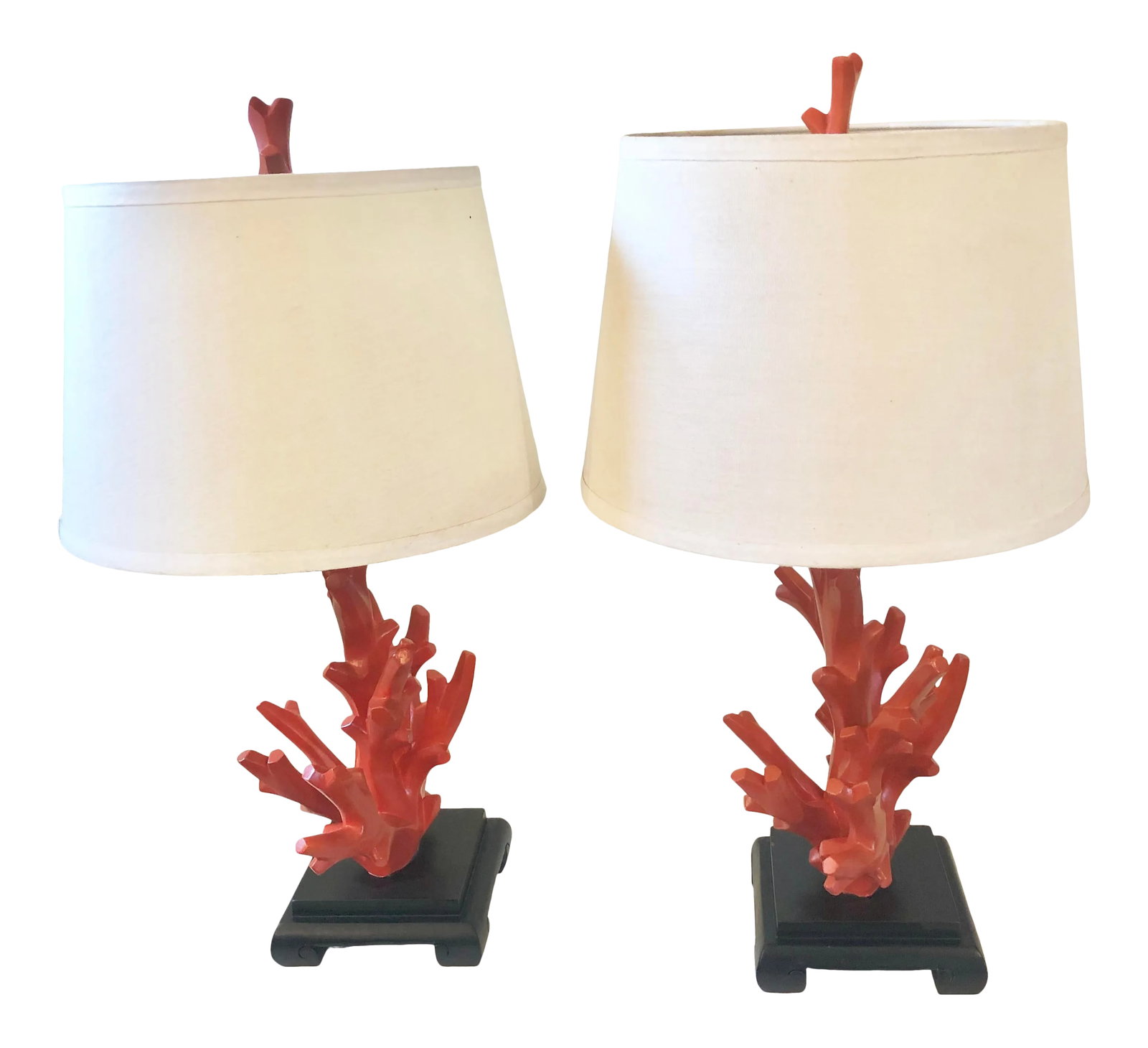 Mid-Century Faux Coral Lamps - A Pair: A pair of Hermes orange wooden faux coral lamps with wooden bases and faux coral finials. Some minor chips in the paint finish. One base has a hairline. It doesn't affect the stability of the lamp. I