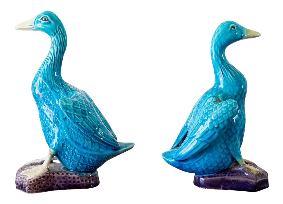 1960s Mid-Century Chinese Ceramic Turquoise Ducks - a Pair: This listing is for a pair of Chinese ceramic ducks glazed in cerulean blue on platform purple glazed base(s) with exposed web feet. Circa 1950s. Marked China underneath. Condition: There is some