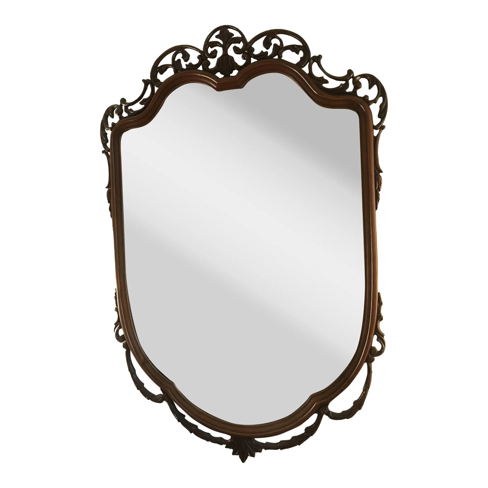 Vintage 1940's Mahogany Shield Mirror: Unique shield shaped mirror with intricately carved trim. The swagging garland trim adds lightness and depth to this vintage piece. Condition: Alterations: Original Condition Unaltered Imperfections: