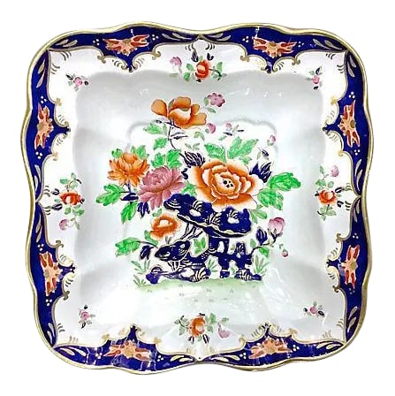 Antique Porcelain Chinoiserie Floral Dish: Antique; 19th century, English, porcelain, dish hand-painted with floral design in the center with floral accents around the perimeter edge with cobalt blue background. Gilt accents. No maker's mark. 
