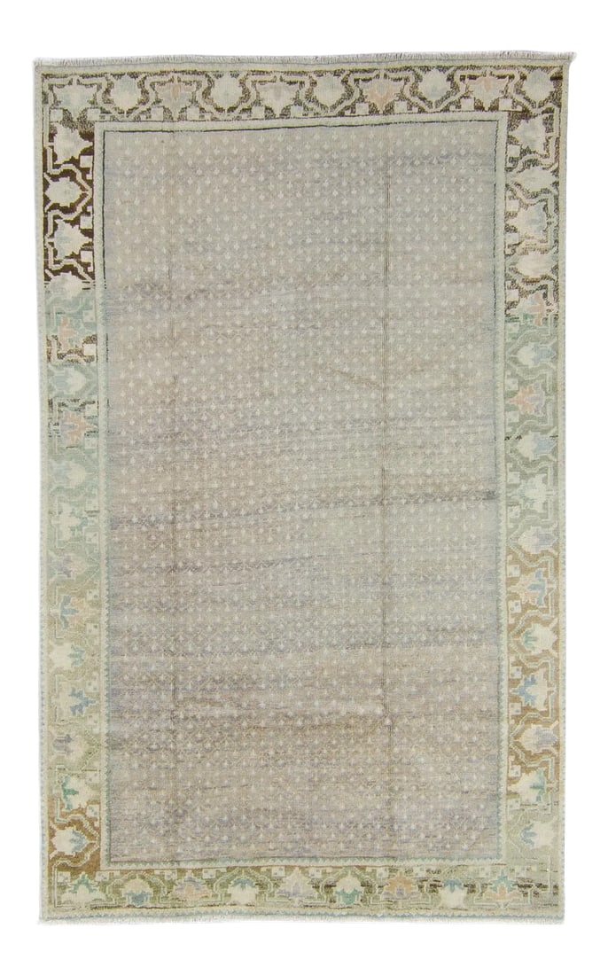 1950s Neutral Wool Pile Hand-Knotted Rug - 4'7" X 7'4": Soft-toned colors such as lavender, blue, mint, peach and brown atop the backdrop of a geometric motif give this vintage rug a mellow feel and would bring a sense of tranquility to your living space.