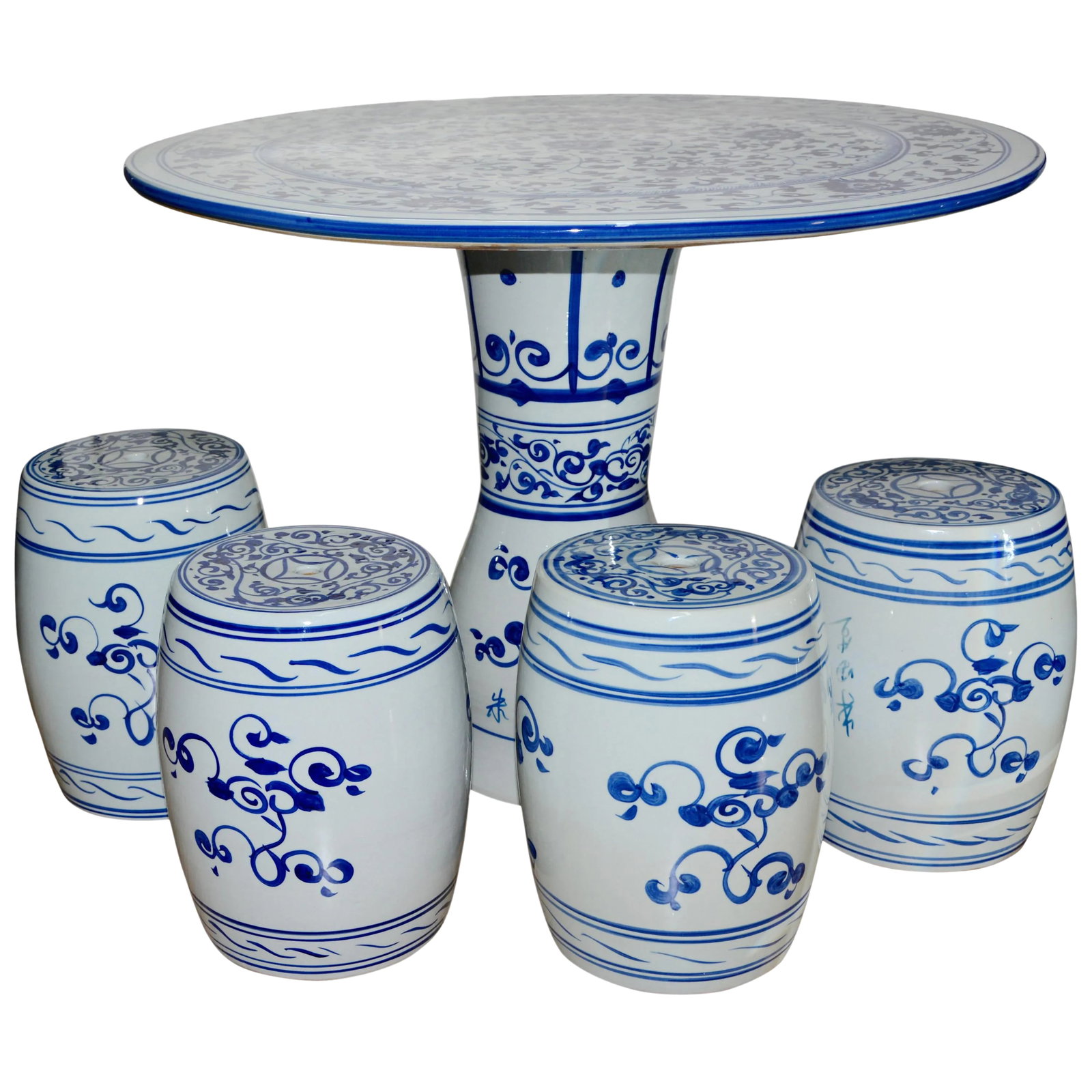 Chinese Hand-Painted Porcelain Garden Table and Stools: Featured is a small size Chinese porcelain garden table and four stools. The table has a white background with hand painted blue design elements. The table is in two pieces. The stools measure 11 inch
