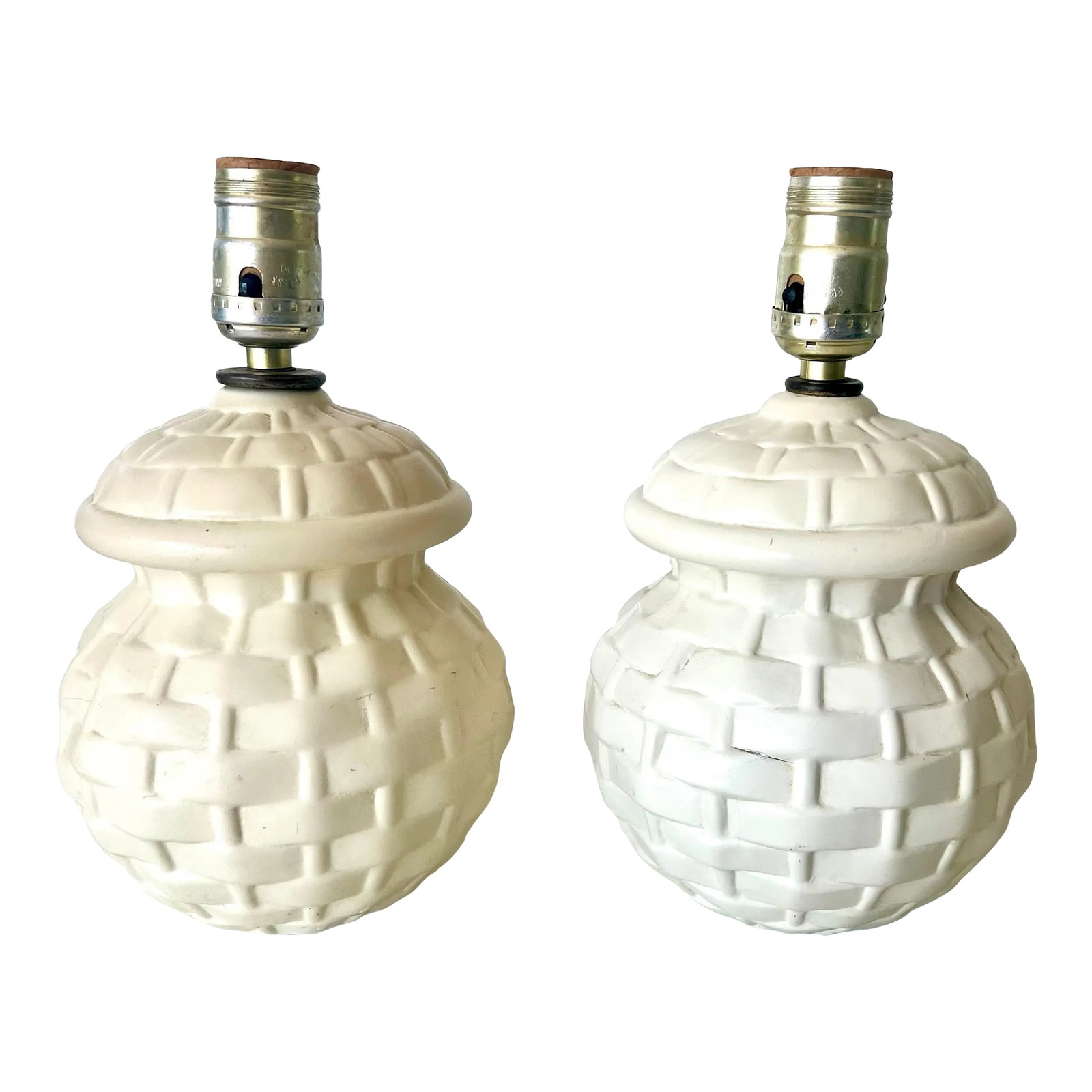 Midcentury Petite Basket Weave Ceramic Lamps- a Pair: This precious pair of ceramic table lamps have a ginger jar shape and basket weave pattern. These are an off white or cream color and do not come with shades. Just pair with any color of clip on shade
