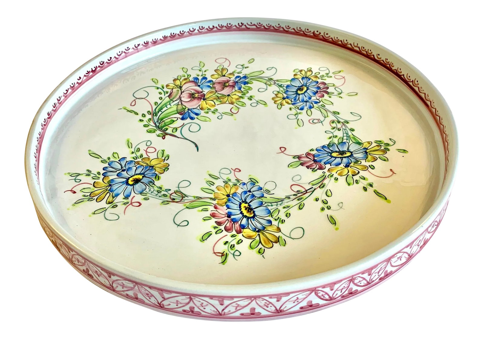 Vintage Hand Painted Ceramic Serving Tray From Portugal: Lovely vintage hand painted tray from Portugal. A generous 13 inches wide with a 1.25 inch high standing rim. The center is decorated with a five sprays of flowers in blue, yellow and plum arrayed in