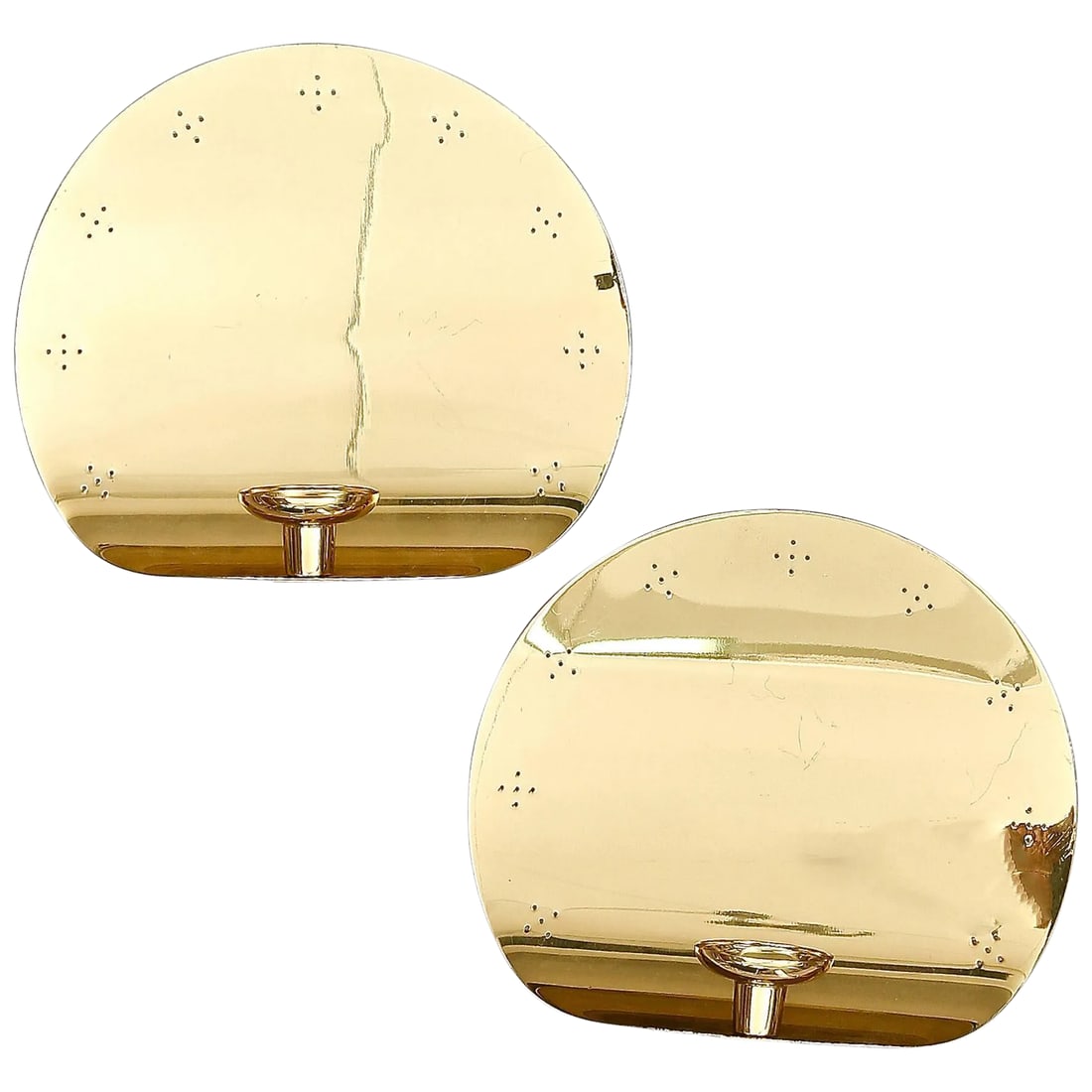 Wall Lights in the Style of Paavo Tynell - a Pair: A pair of wall lights in the style of Paavo Tynell, produced by Borens Boras, circa 1970th. Perforated polished brass with single candelabra socket and candleholder on each fixture. Existing wiring,