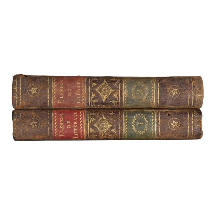 1810 French Brown Leather Bound Antique Books- Set of 2: This exquisite set of two antique books, bound in rich brown leather, dates back to 1810, embodying the elegance and craftsmanship of early 19th-century French bookbinding. Each volume showcases finel