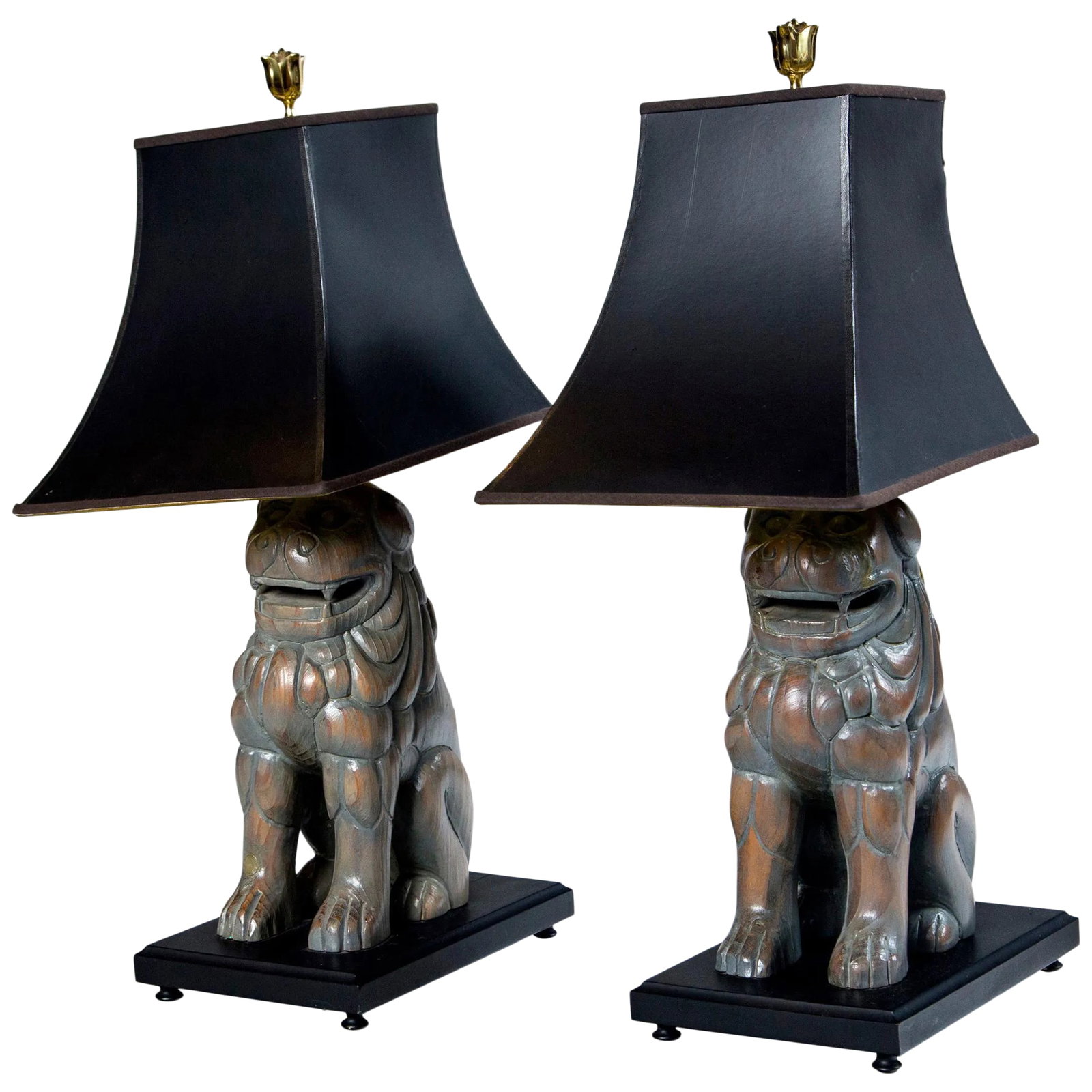 Carved Wood Foo Dog Lamps by Sarreid - a Pair: A pair of carved wood Foo Dog lamps by Sarreid of Spain. Shaped black paper lamp shades with gold interiors. Dogs are seated on black painted wood bases. Dogs alone are 5 inches wide by 7.5 inches