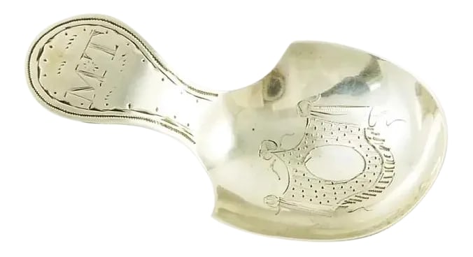 Antique Early 19th Century French Silver Tea Caddy Spoon with Bright Cut Engraving: An early 19th C French silver caddy spoon. The caddy spoon is embellished with a bright-cut engraving of drapery valance in the bowl. Further bright-cut engraved work details the handle along with a m
