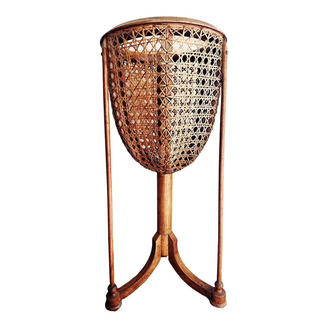 1910s Carved Fruitwood Plant Stand With Cane Basket: Antique circular carved rim fruitwood plantstand clad in cane over interior wooden skeleton atop a tripod base. Three supports run the length down to each foot for stability and handsome elegance.