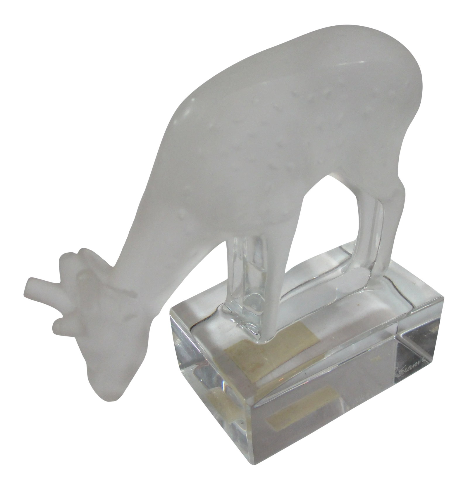 Lalique Deer Crystal Figurine: A Lalique crystal sculpted figurine, hand crafted with a frosted crystal deer, grazing on a clear crystal base. It is signed Lalique France on the side of the base and has a paper label "Made in Franc