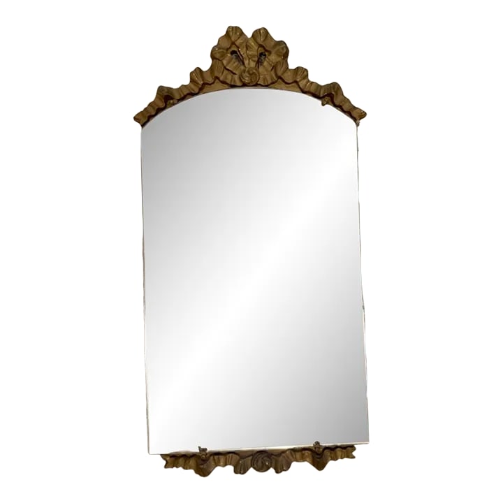 Vintage Mid 20th Century Gilt Carved Mirror: Carved golden bow mirror. Mirror is vintage and has minor ghosting/oxidation. So chic in a powder bath or above a dresser. Condition: Alterations: Original Condition Unaltered Imperfections: Some