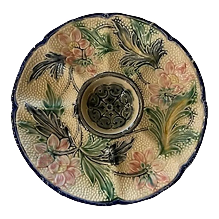 Belgium Wasmuel Majolica Oyster Plate: A Belgium Wasmuel majolica oyster plate with pink flowers, green and deep blue leaves and blue edge. The butter well measures 4" diameter. Circa 1890. Condition: Alterations: Original Condition