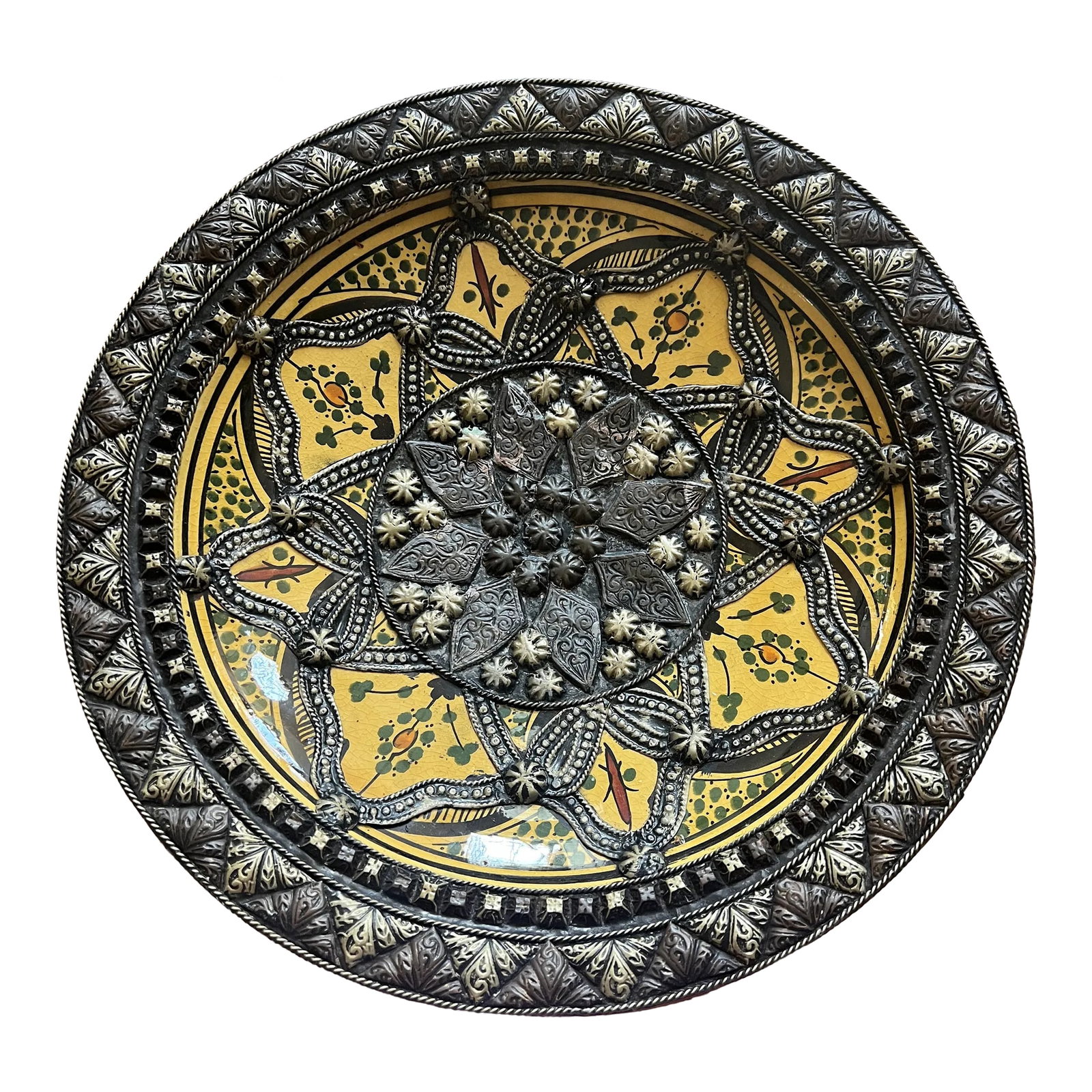 1980s Moroccan Inlaid & Engraved Ceramic Plate: Handcrafted decorative glazed ceramic bowl with great details. Overlaid with a combination of Berber engraved metal. Condition: Alterations: Original Condition Unaltered Imperfections: Some