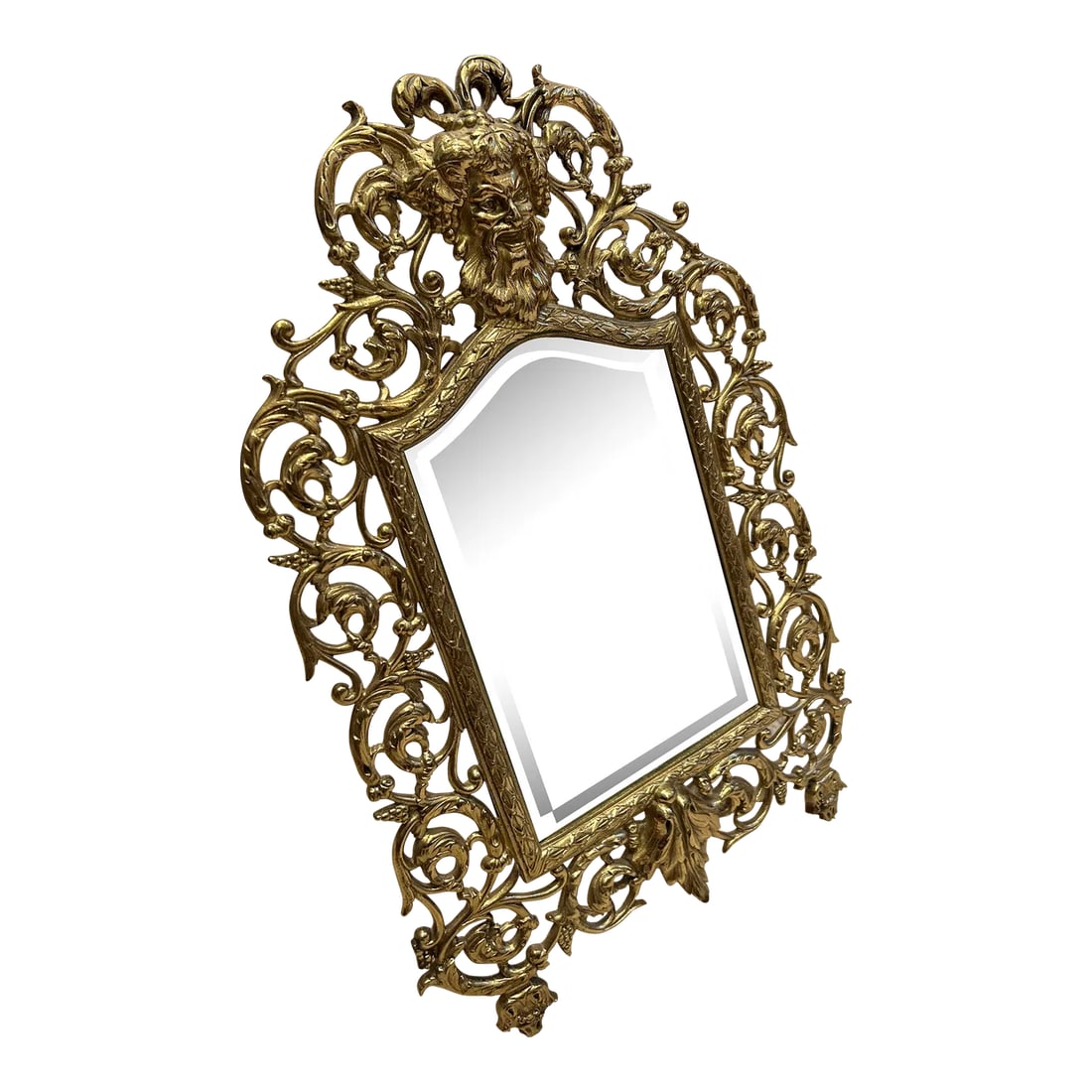 Antique 19th Century P. E. Guerin Brass Vanity Tabletop Mirror: Antique brass vanity or wall hanging mirror, signed P. E. Guerin, NY in upper left corner of the reverse, c. 1890. Elaborate vegetal scrollwork with head of Bacchus and grapes. Rear feet are stamped N