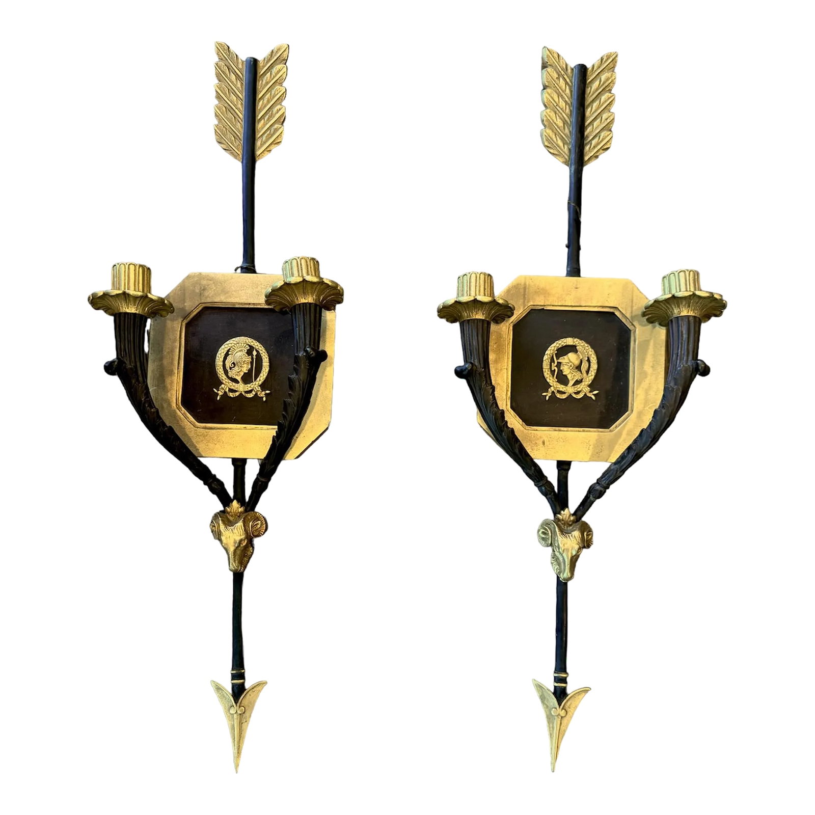 Pair of Roman Neoclassical Gilt and Bronze Candle Sconces With Arrow Motif: Mid-Century, Neoclassical iron candle sconces in the manner of Gio Ponti and Tomaso Buzzi surrealist arrow motifs, Greek Roman soldier profile, and ram's head gilt accents. A treasured find for