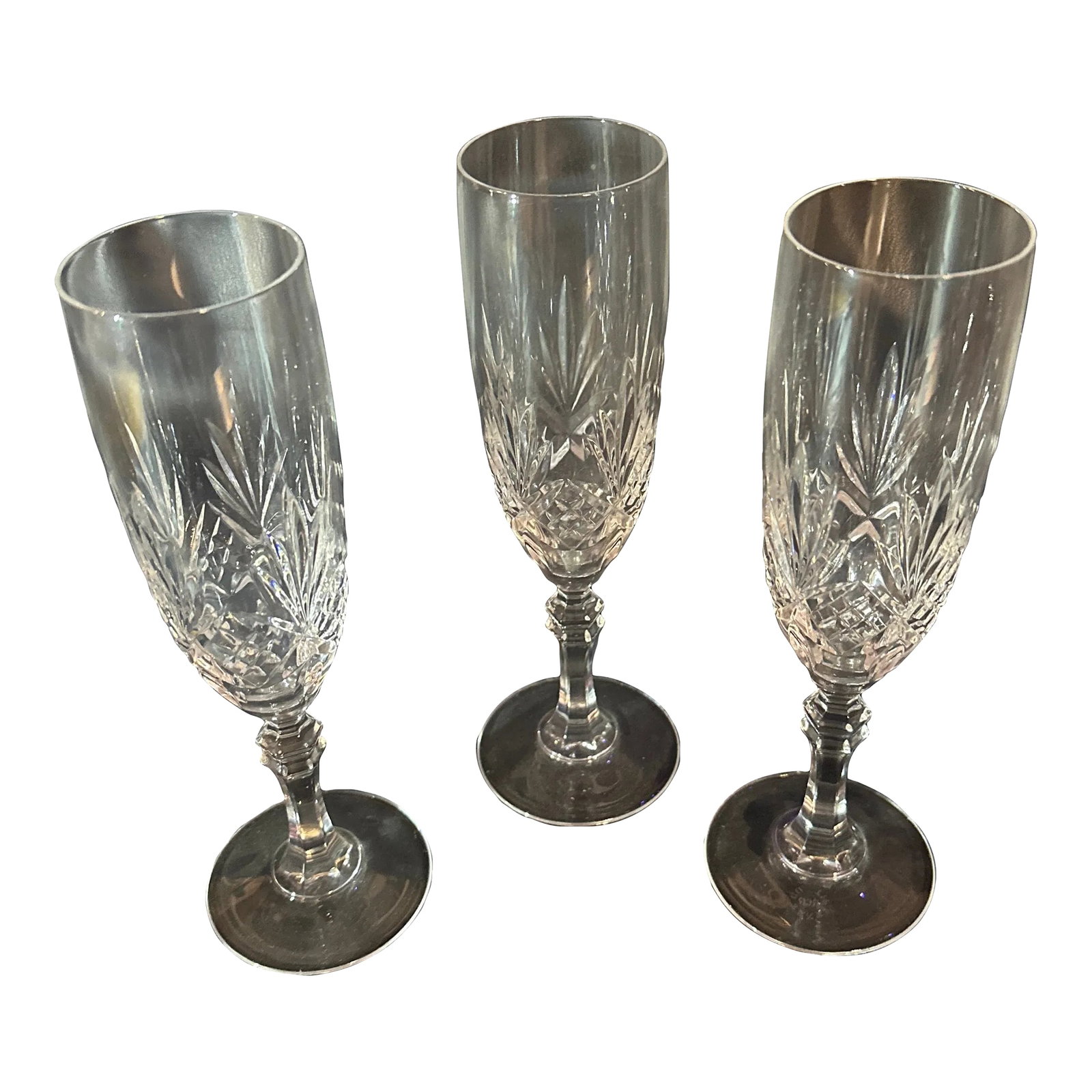 Late 20th Century Tiffany & Co. Newport Champaign Flutes- Set of 3: Newport by Tiffany & Co. Description: Clear, Fan Cut, Criss Cross Pattern: Newport by Tiffany Status: Discontinued. Circa: 1988 - 1999 Height: 8 1/8 in Width: 1.9 in 2.67 in base Blown Glass