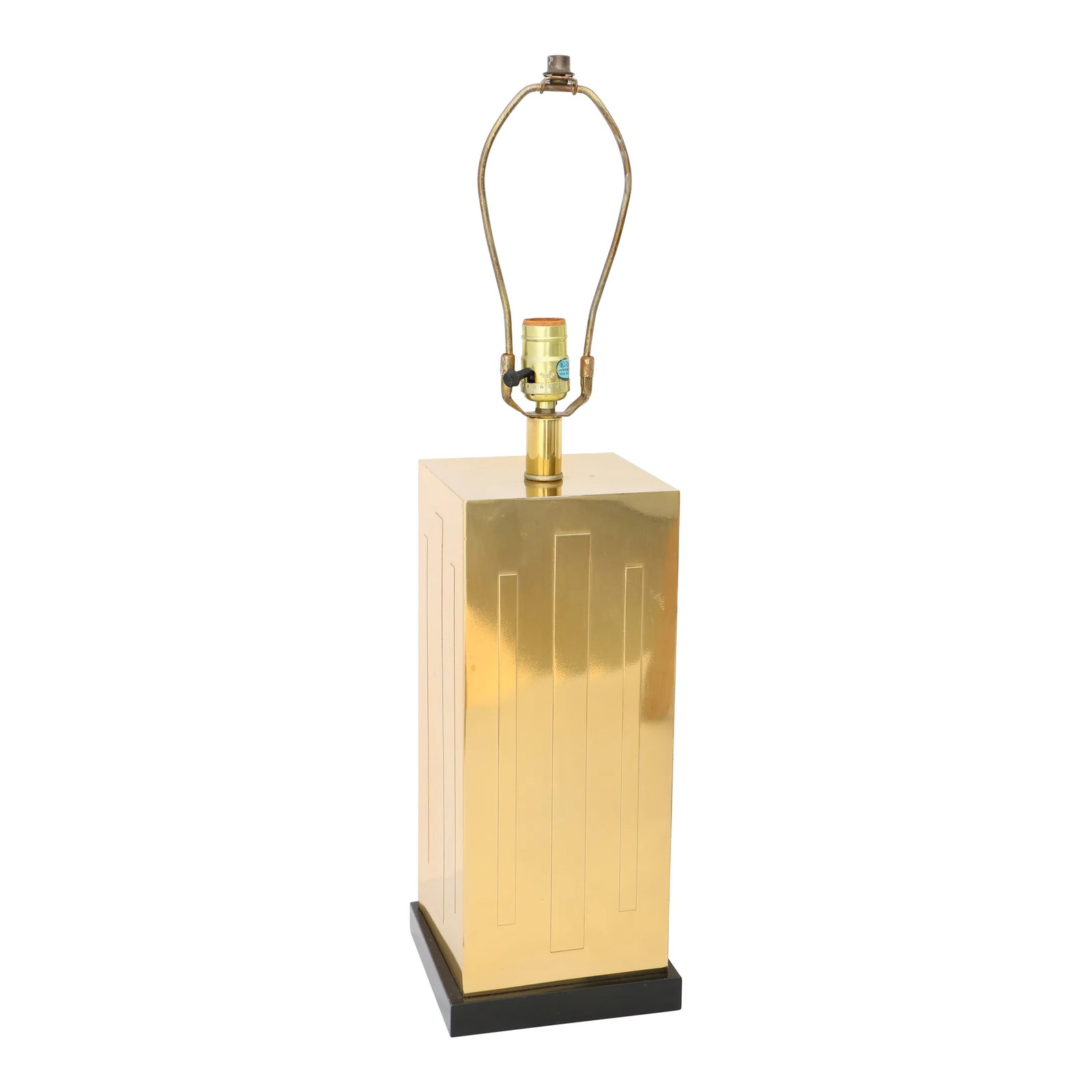 Lacquered Brass Skyscraper Table Lamp: Vintage tower form table lamp in lustrous coated brass on a block cut black wooden base. Each side has three raised rectangular shapes. It measures 26.5" to the top of its finial, 19.5" tall to the