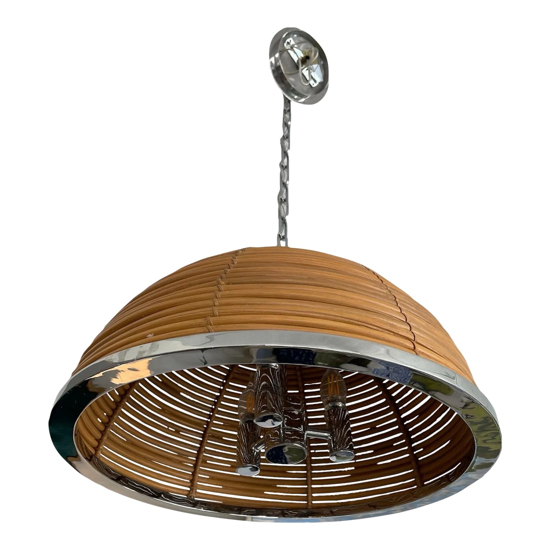 Corbett Dome Rattan & Chrome Chandelier: Carayes takes an industrial shape and infuses it with a flavor of the tropics. Hand-cut pieces of sustainable rattan form the shade, its natural texture creating an inspired contrast with the