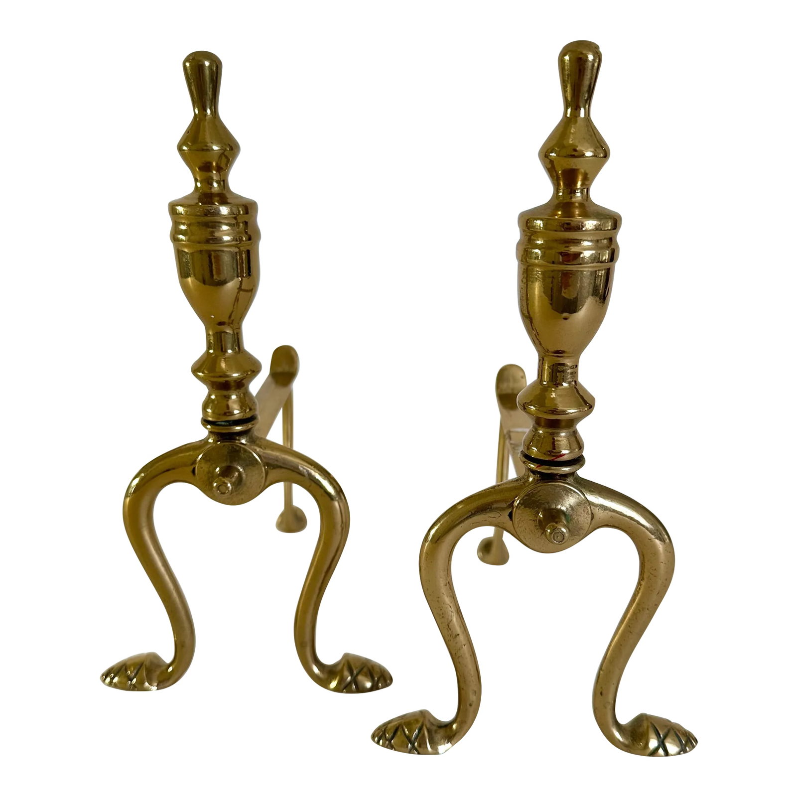 Pair of Late 19th Century Victorian Brass Fire Dogs: Pair of Victorian brass fire dogs with splayed cabriole legs, cross detail feet and turned brass finials. Each item measures 5" W X 6-3/4" D X 9-3/4" H. These have been more recently cleaned and