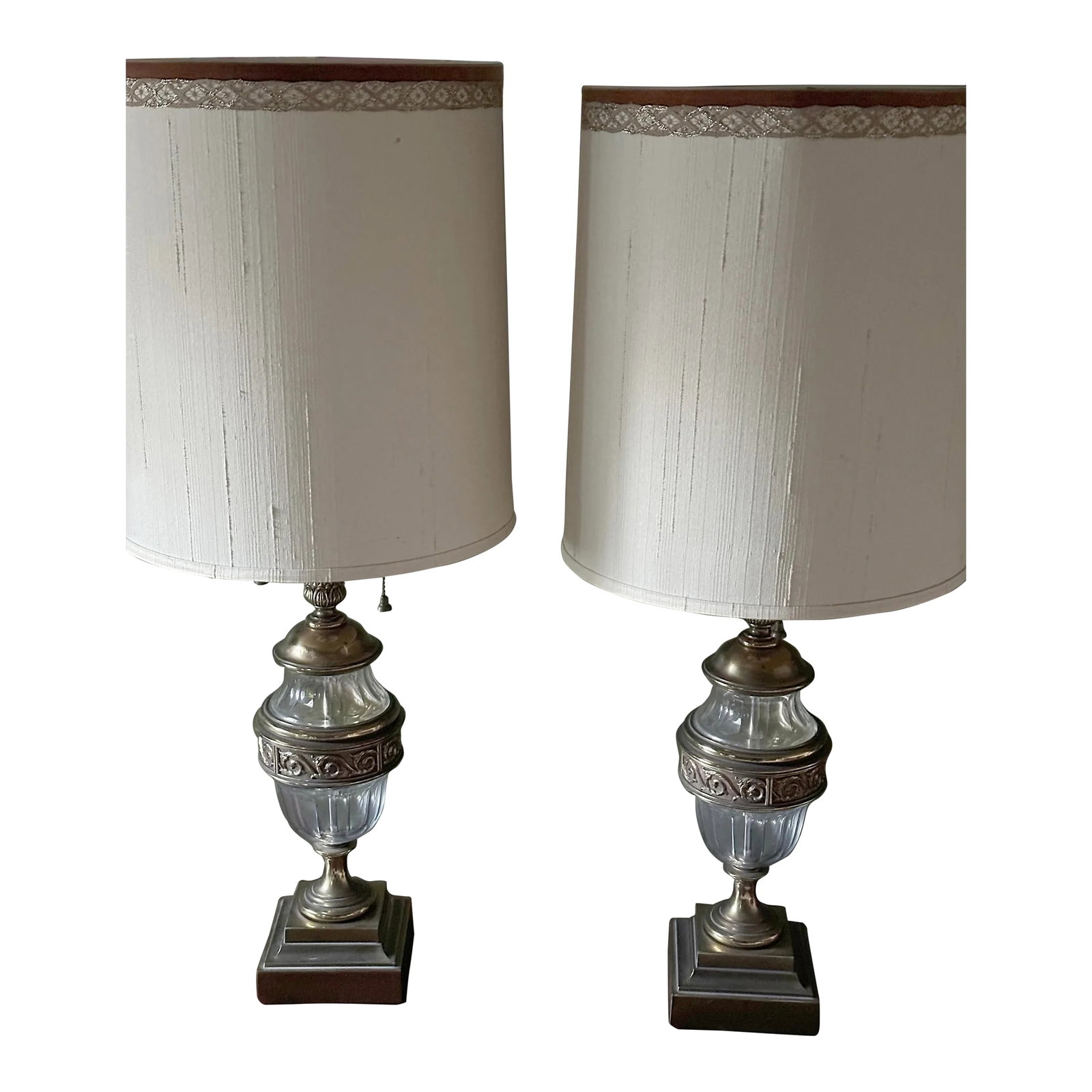 Pair of 1940s Stiffel Hollywood Regency Brass & Glass Table Lamps: A pair of vintage Stiffel Hollywood Regency brass and glass table lamps, probably 1940s. Each comprising a thumb-molded glass urn with brass cap, scrolled-cast banding and circular foot on stepped squ
