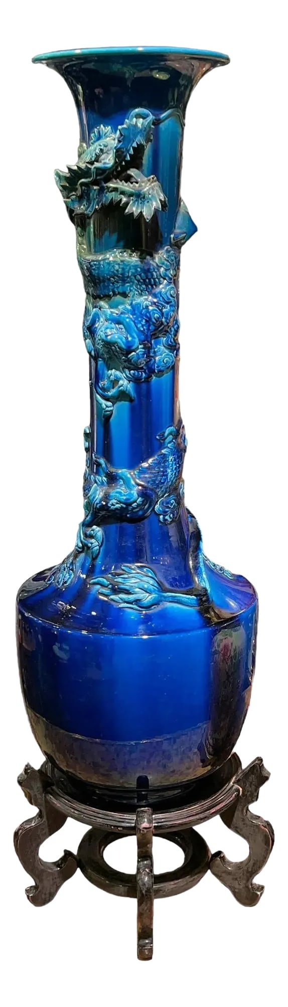 very large Japanese Blue Flambe Glazed Ceramic Dragon Vase: Very tall Japanese ceramic vase with blue flambe glaze and the winding figure of a dragon. With wooden stand. Vase alone 30 1/2 inches tall. Stand 6 3/4 inches tall. Apparently unsigned. Condition: