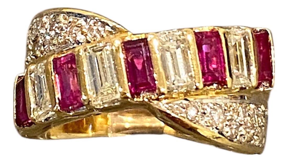 18k Gold Ruby and Diamond Crossover Ring, Size 6.5: Crafted in 18K yellow gold, the ring showcases a crossover design with alternating baguette-cut rubies and diamonds over pave set round diamonds. Rubies: 1.08 ctw. (stamped) Diamonds: 0.95 ctw. (stamp