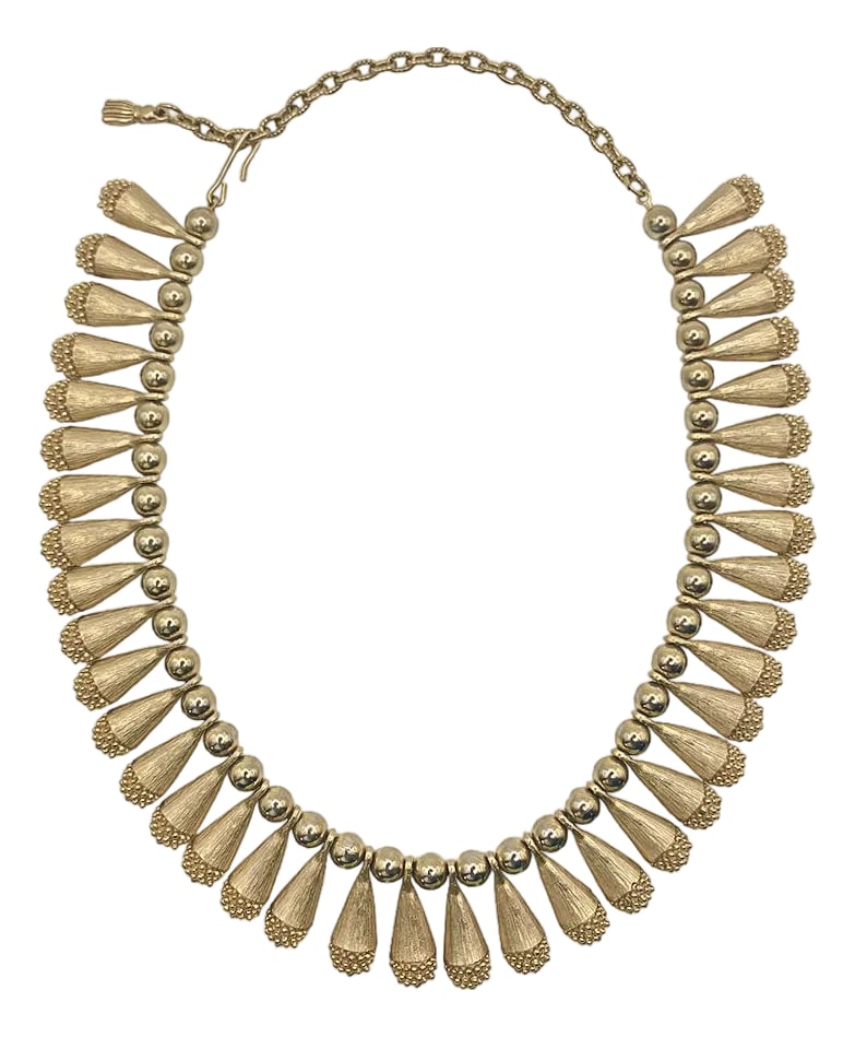 Vintage Egyptian Revival Bib Collar Necklace: 1960s Egyptian revival-style bib necklace is a fantastic statement piece, either completing a look or transforming it to the next level. Gold tone metal. About 5" of adjustable length with fish-hook