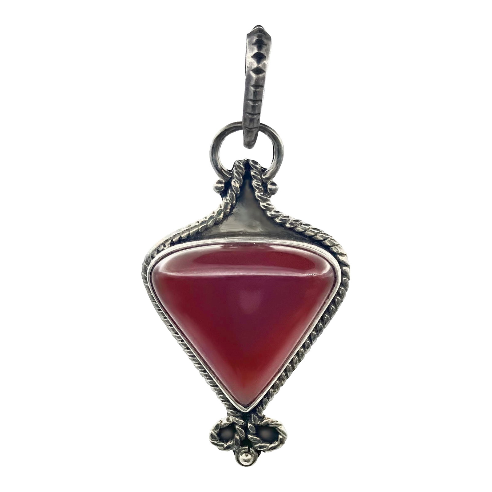 Vintage Carnelian Gemstone and Sterling Silver Pendant: Earthy red carnelian gemstone set in sterling silver with beautiful detailing. A combination of intricate metal work design with strong sterling setting to guard the triangular blood-colored stone.
