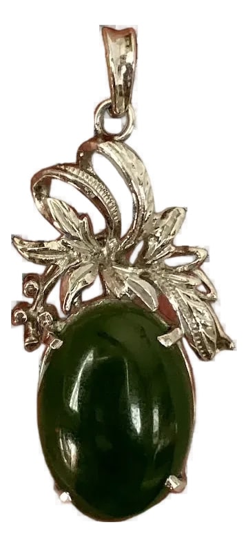 1950s 18k White Gold Jade Pendant: Unique, 1950s 18k white gold pendant. The pendant measures 1 1/2" from top to bottom and features an oval shaped jade stone, prong set in an elaborate scrolled setting. The oval stone measures 1/2" x