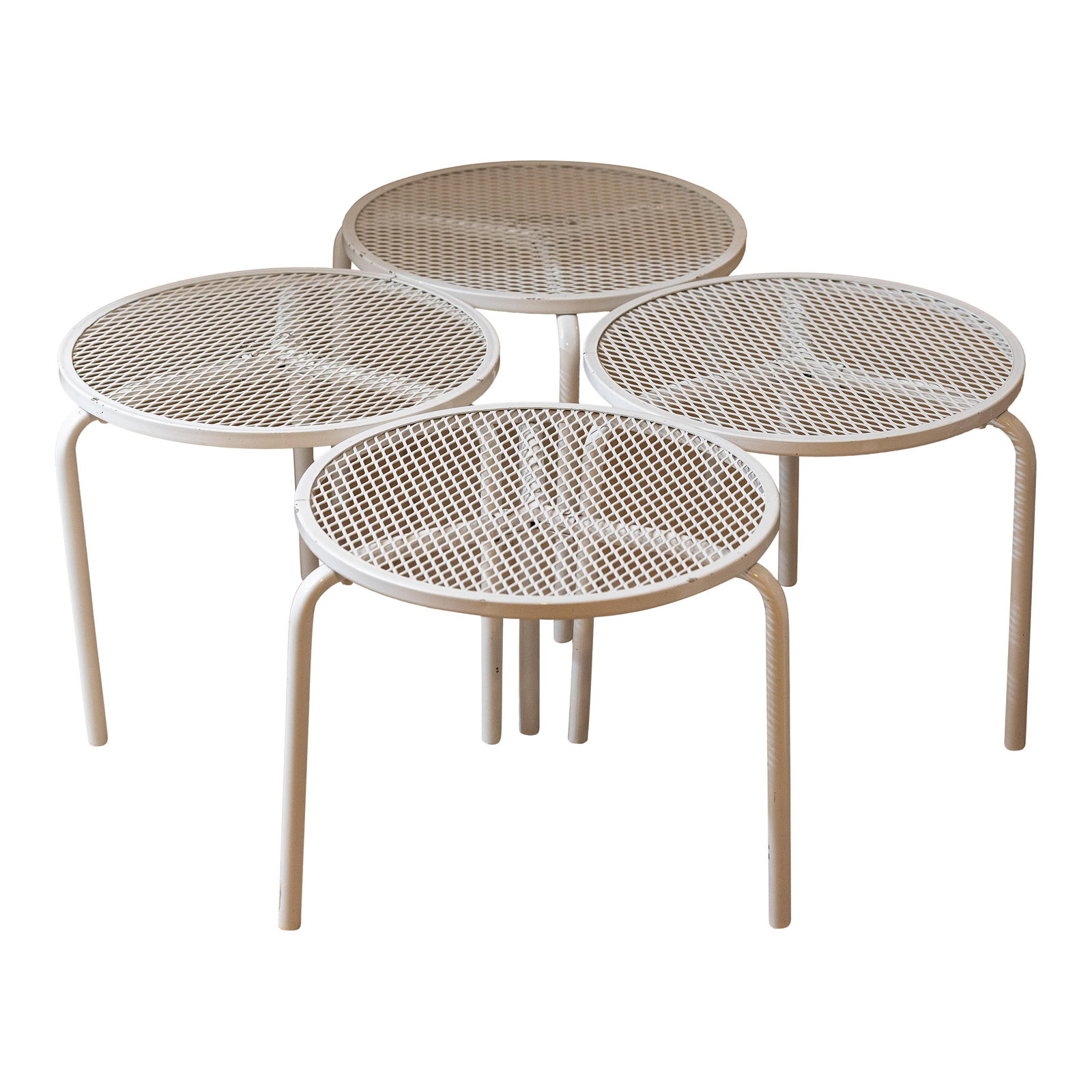 1960s Mid-Century Italian Style White Metal Mesh Tripod Stacking Tables - Set of 4: This exceptional set of four stacking cocktail tables captures the airy, industrial aesthetic of 1960s European patio design. Attributed to makers such as Emu Italy or Woodard, these pieces are a