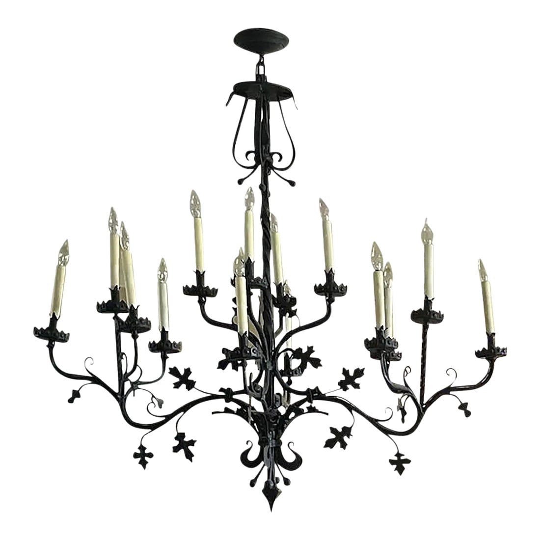 Mid 20th Century Large Mid-Century Wrought Iron Chandelier With Leaf Details: Large-scale mid-20th century hand-forged wrought iron chandelier featuring a twisted central stem with scrolling arms and decorative iron leaf details throughout. The chandelier is finished in a dark