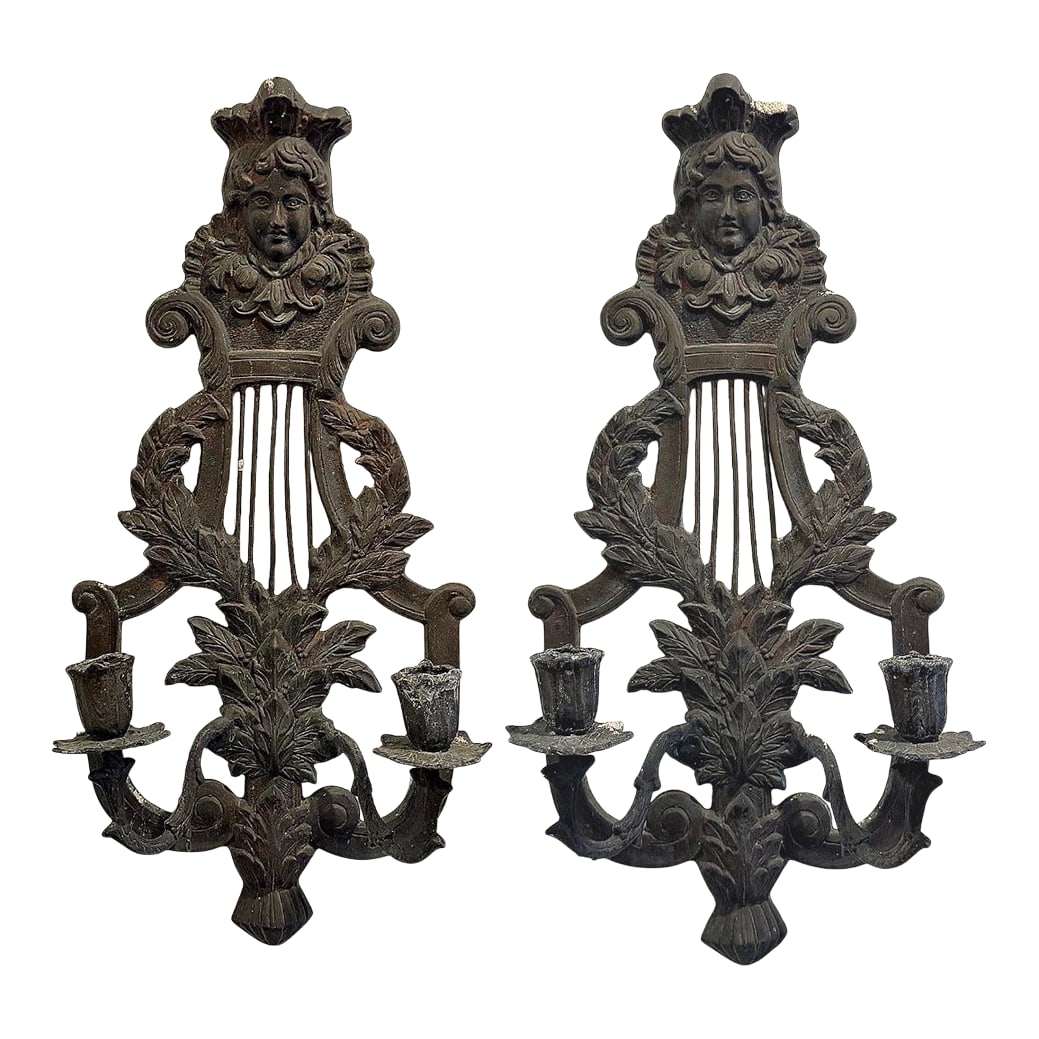 Late 19th Century Pair of Antique French Victorian Bronze Figural Wall Sconces With Original Patina: Striking pair of antique French Victorian wall sconces featuring finely cast figural faces, scrolling arms, and classical lyre motifs. Crafted in solid bronze with a deep, time-earned patina, these