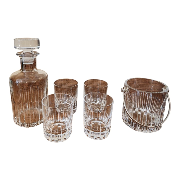 1980s Baccarat Rotary Glasses, Decanter, and Ice Bucket: The Baccarat Rotary pattern was produced between 1981-2016 in an Art Deco style. This set consists of: Four double old-fashioned glasses (4 1/8 H x 3 1/4 W) One whisky decanter (10 1/4 H x 4 1/8 W)