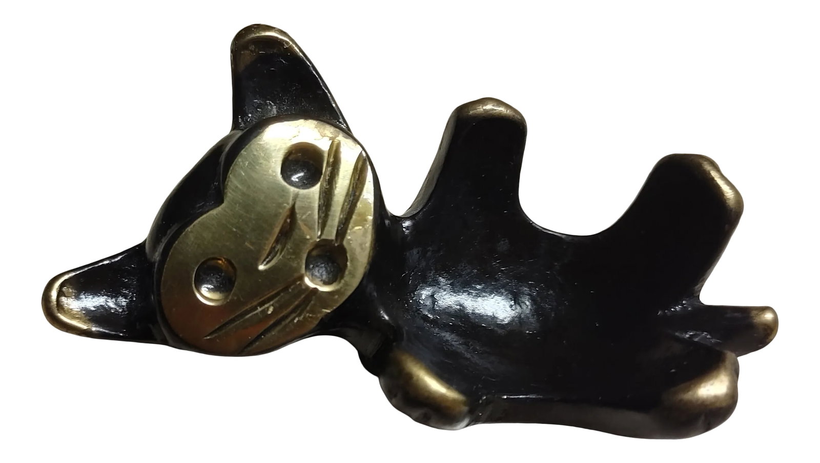 Mid-Century Modern Brass Cat Candle Holder Att. To Walter Bosse: This tiny brass cat fills a room with delight, with or without a round candle in it. It lies on its back, its small brass feet up in the air, a quizzical expression on its face. Attributed to Walter