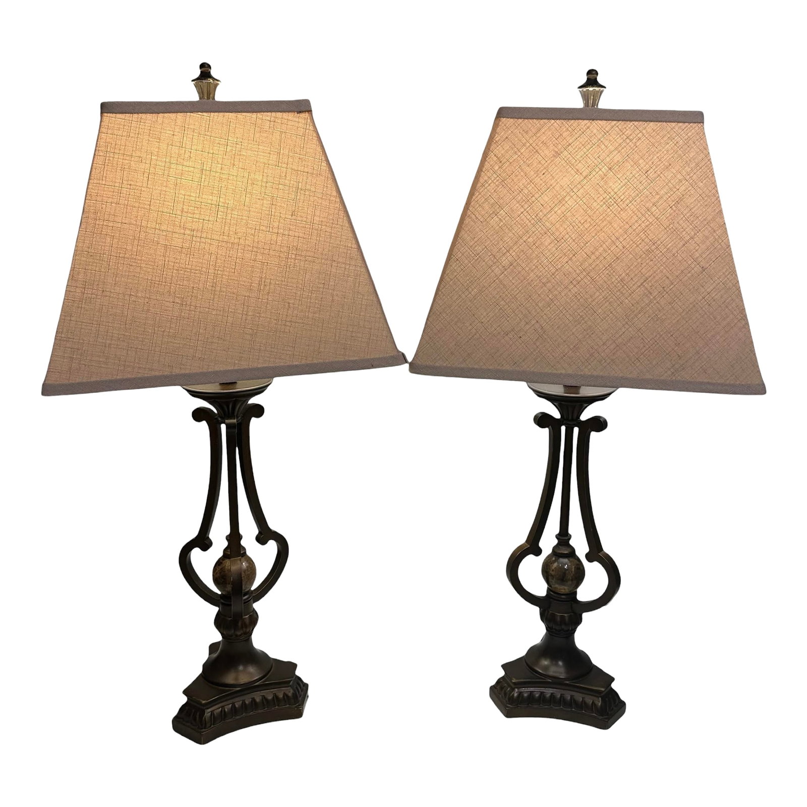 A Pair of Vintage Marble and Bronze Table Lamps: A pair of bronze and marble lamps with a metal and ceramic body. This set of table lamp fits perfectly in mansion or any luxurious space. The shades features a traditional shape and soft linen in colo