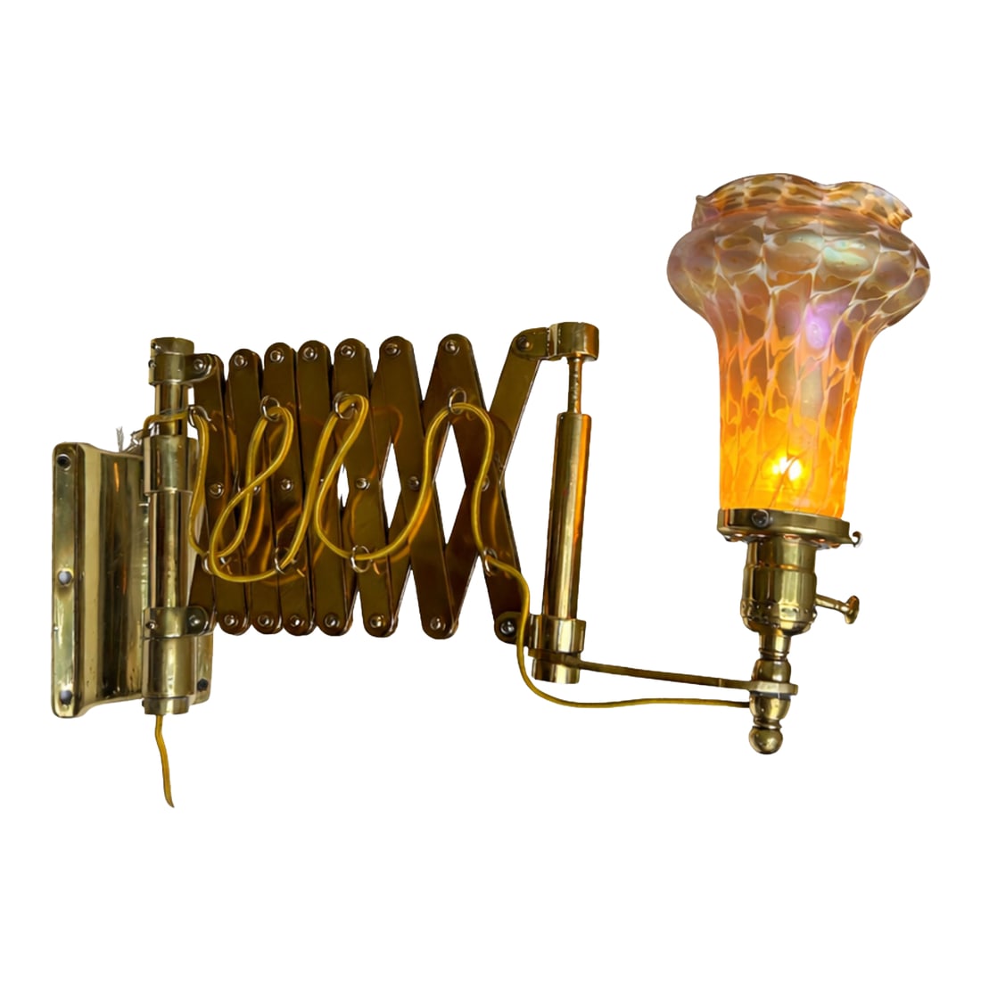 Vintage Brass Scissor Wall Lamp With Iridescent Glass Shade: Vintage brass scissor wall lamp featuring an adjustable accordion arm and a striking iridescent art glass shade. The sculptural shade displays warm amber tones with opalescent undertones, creating a