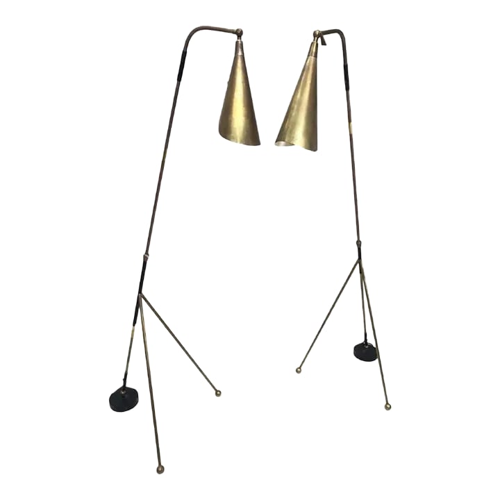 Mid 20th Century Bronze Adjustable Floor Lamps - a Pair: A near pair of bronze adjustable floor lamps on a black base with two bronze ball-capped legs. Bronze sculptural come form shades. Black accent trim (lamp trims vary slightly). Interesting height adju