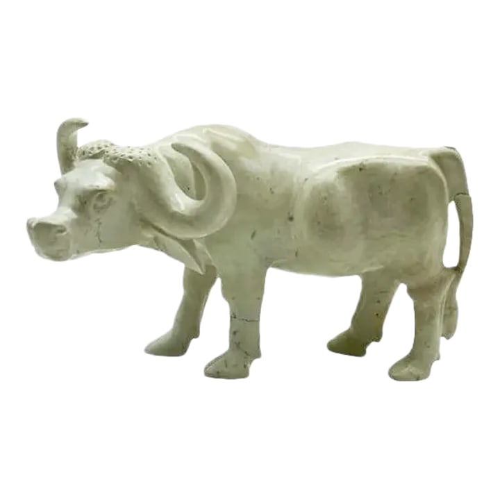 Hand-Carved Soapstone Cattle: A found soapstone cattle statue, carved with realistic details captured in the cattle's face, bringing the statue to life with its expressive features and gentle demeanor. Though the statue has