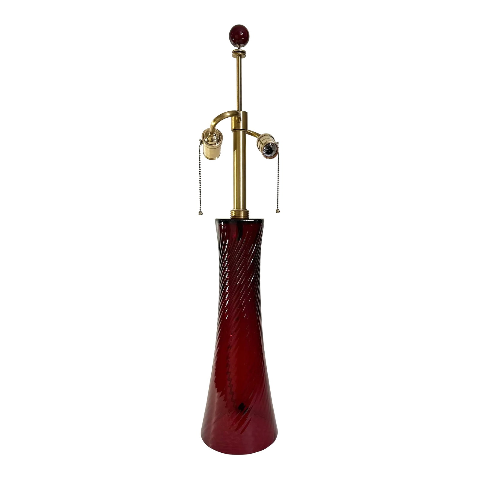 2000s Red Seguso Murano Glass Lamp Designed by John Hutton for Donghia: Murano glass lamp in cranberry red glass designed by John Hutton for Donghia and manufactured by Seguso. Glass body has a spiral design to glass. Original glass ball finial. Brass fittings and on/off