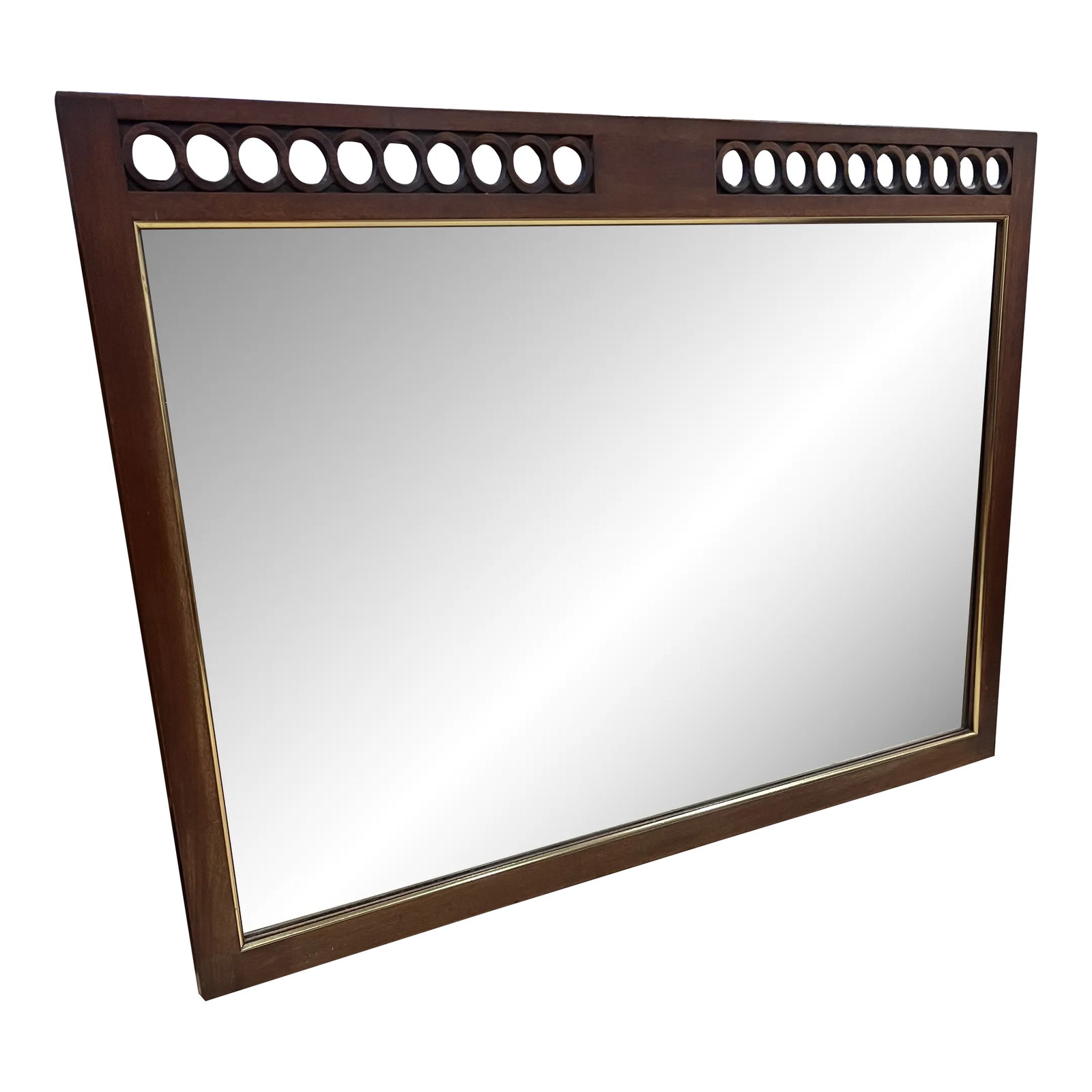 Mid Century Modern Sculpted Mirror by John Stuart: Mid Century Modern Sculpted Wall Mirror designed by John Stuart, made of walnut, accented with continuous geometric circles across the length of the top. Condition: Alterations: Original Condition Una