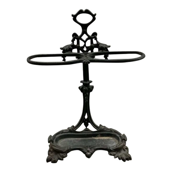 Early 20th Century Antique Cast Iron Umbrella Stand: This heavy cast iron umbrella stand hold multiple umbrellas and can also act as decorative piece in a foyer or hallway. There is a removable tray at the bottom for emptying water once the umbrellas