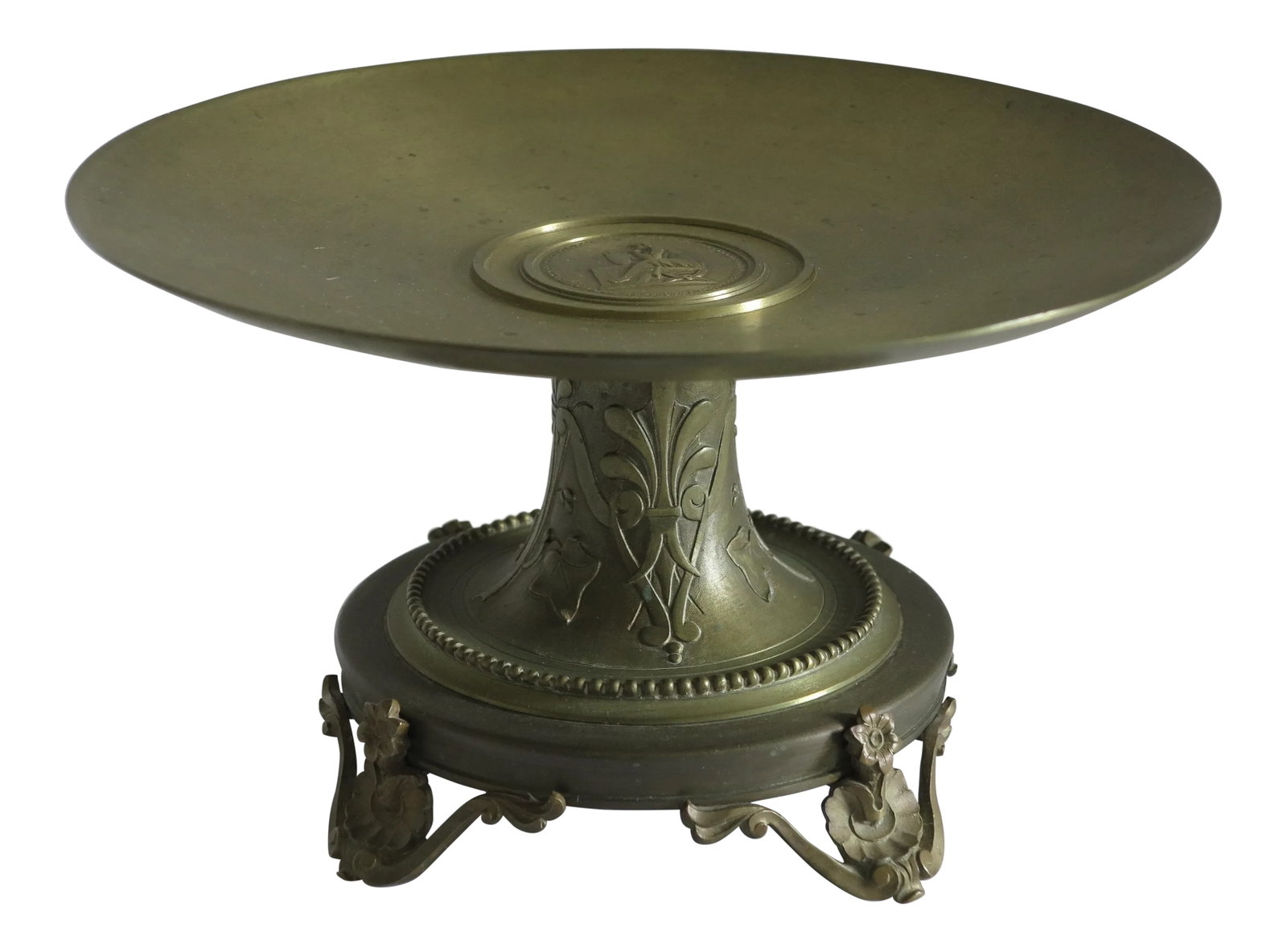 1890 Victorian French Solid Bronze Neoclassical Tazza: A stunning late Victorian French bronze tazza with a central medallion featuring a neoclassical motif and a base featuring a motif of palmettes, flowers and vines. Condition: Alterations: Original