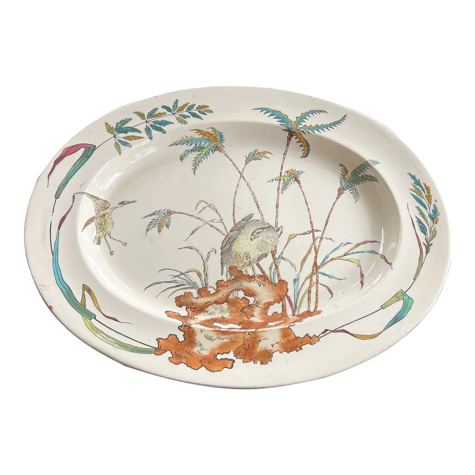 Antique 1877 English Copeland Egret Palm Serving Platter: A large polychrome transfer ware serving platter from Copeland in 1877. This piece is decorated with colorful palms and reeds, dynamic birds and a butterfly. The colors include blue, green, pink,