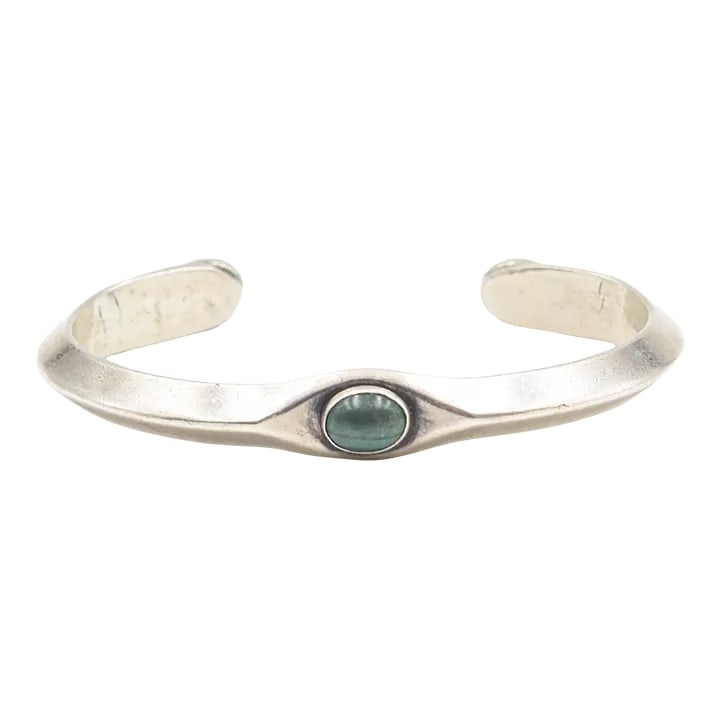 Vintage Navajo Native American Malachite Sterling Silver Cuff Bracelet by Russell Sam: This is part of Chairish's Costume Jewelry assortment. Vintage Navajo Native American Russell Sam sterling silver handmade cuff bracelet one bezel set oval malachite in the front and two additional