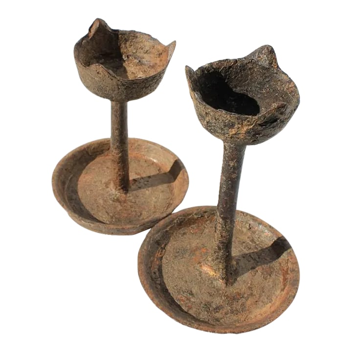 19th Century Primitive Iron Candle Holders - a Pair: These rare oil burning iron lamps were once used as a light source in Buddhist temples. Very primitive, lamps would look beautiful showcased on a book shelf or fireplace. Place a votive for an updated