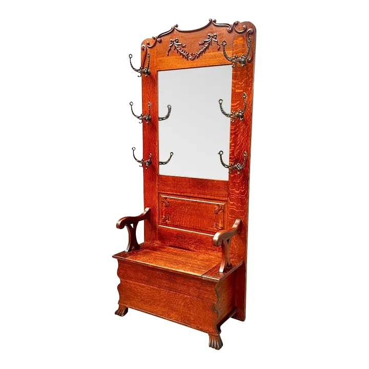 Late 19th Century Antique Victorian Tiger Oak Hall Tree With Ribbon Carved Crest & Beveled Mirror: With our absolute highest compliments Bay Colony Antiques takes the utmost pleasure in offering this wonderful late 19th century antique hall tree. We are always in search of rare and unusual antique 