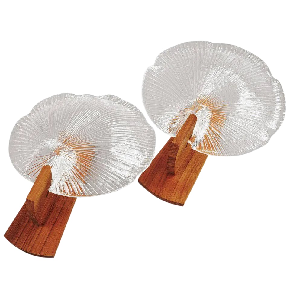 Sconces by Eva Englund - a Pair: A pair of sconces by Eva Englund. Glass and teak. Measure: H 12.5" Existing European wiring, rewiring available. Condition: Alterations: Original Condition Unaltered Imperfections: Some Imperfections