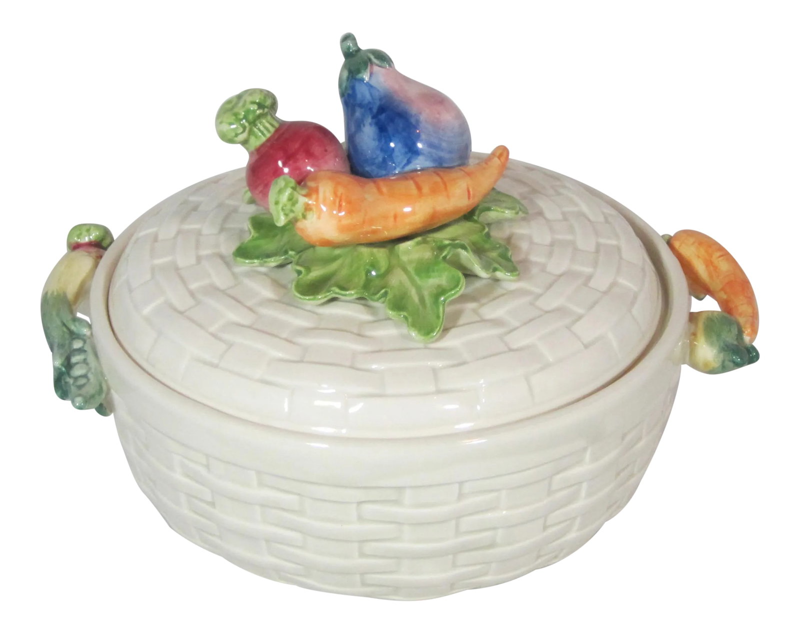 1980s Fitz & Floyd Vegetable Round Covered Bowl: Fitz and Floyd 2 quart ironstone round casserole. It is decorated with a allover basket weave design, and applied colorful vegetables of carrots, eggplant, turnip, and peas on the cover and handles.