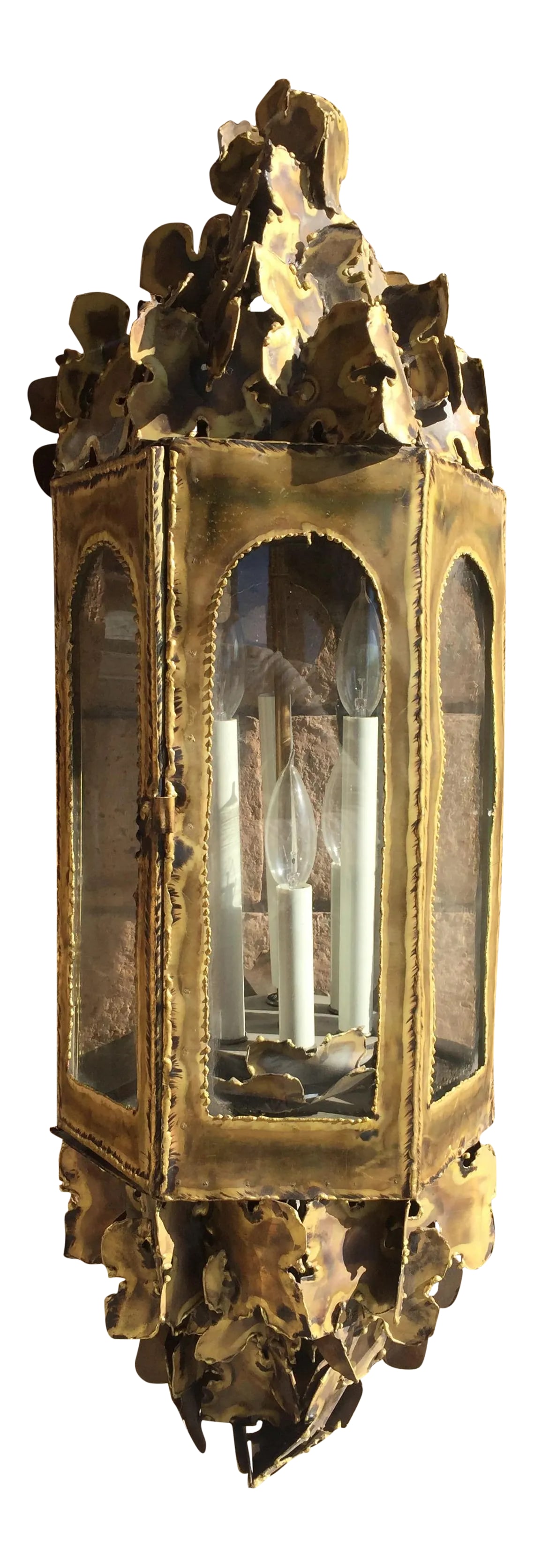 Vintage Tom Greene Brutalist Brass Lamp: Mid-century brutalist brass lantern pendant by Tom Greene. Lighting features six staggered candlestick lights with hand-soldered brass sculptural accents. Condition: Alterations: Original Condition